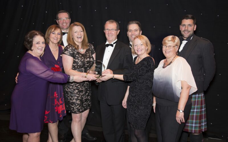 Photograph of Cairn staff receiving excellence award